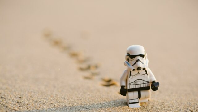 A stormtrooper walking in sand is the feature image of the article.