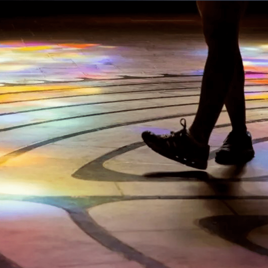 Human lower silhouette walking in a colored floor