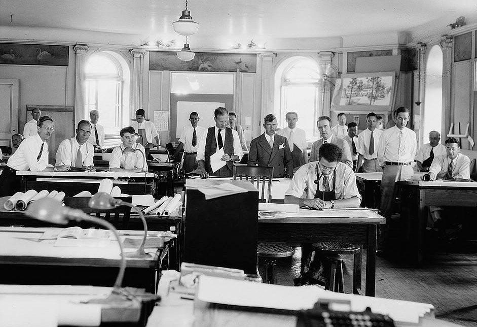 Historic architecture drafting office with architects working on manual technical drawings before the digital era
